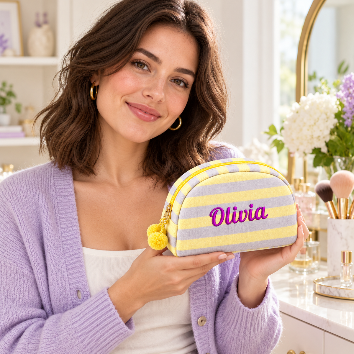Adult model holding the personalized lemon and lilac striped makeup pouch.