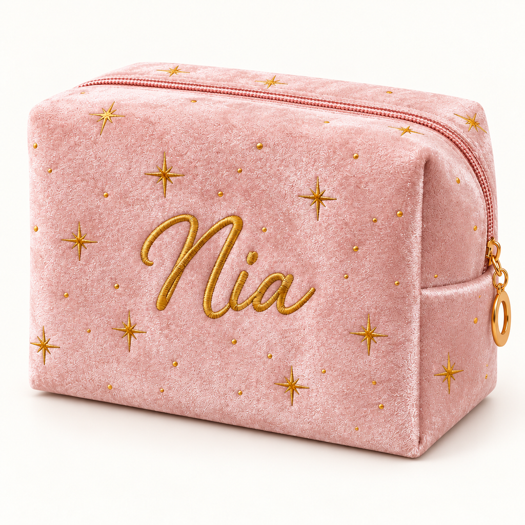Blush pink velvet makeup bag with gold stars and example embroidered name Nia.